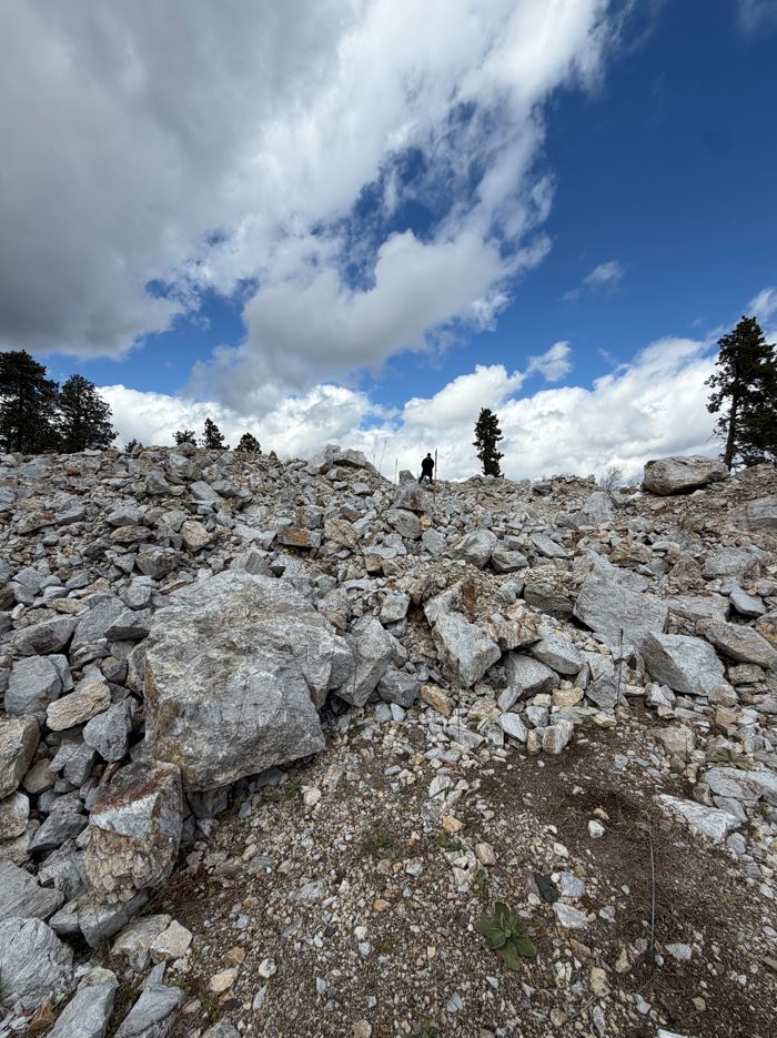 Gerardo standing on a rocky hill