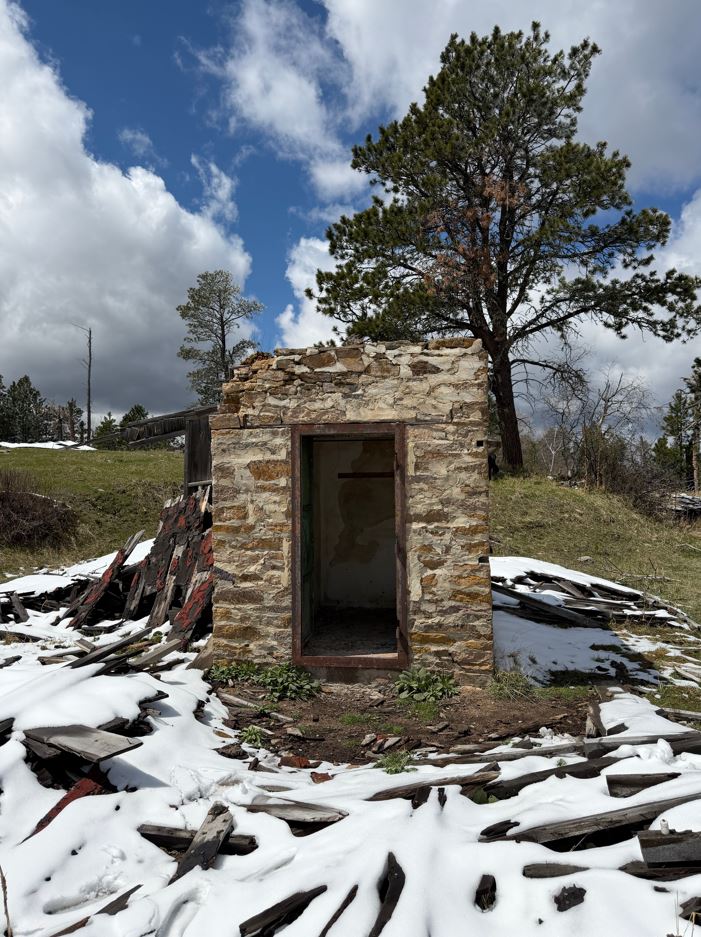 old forgotten vault door left standing in snow